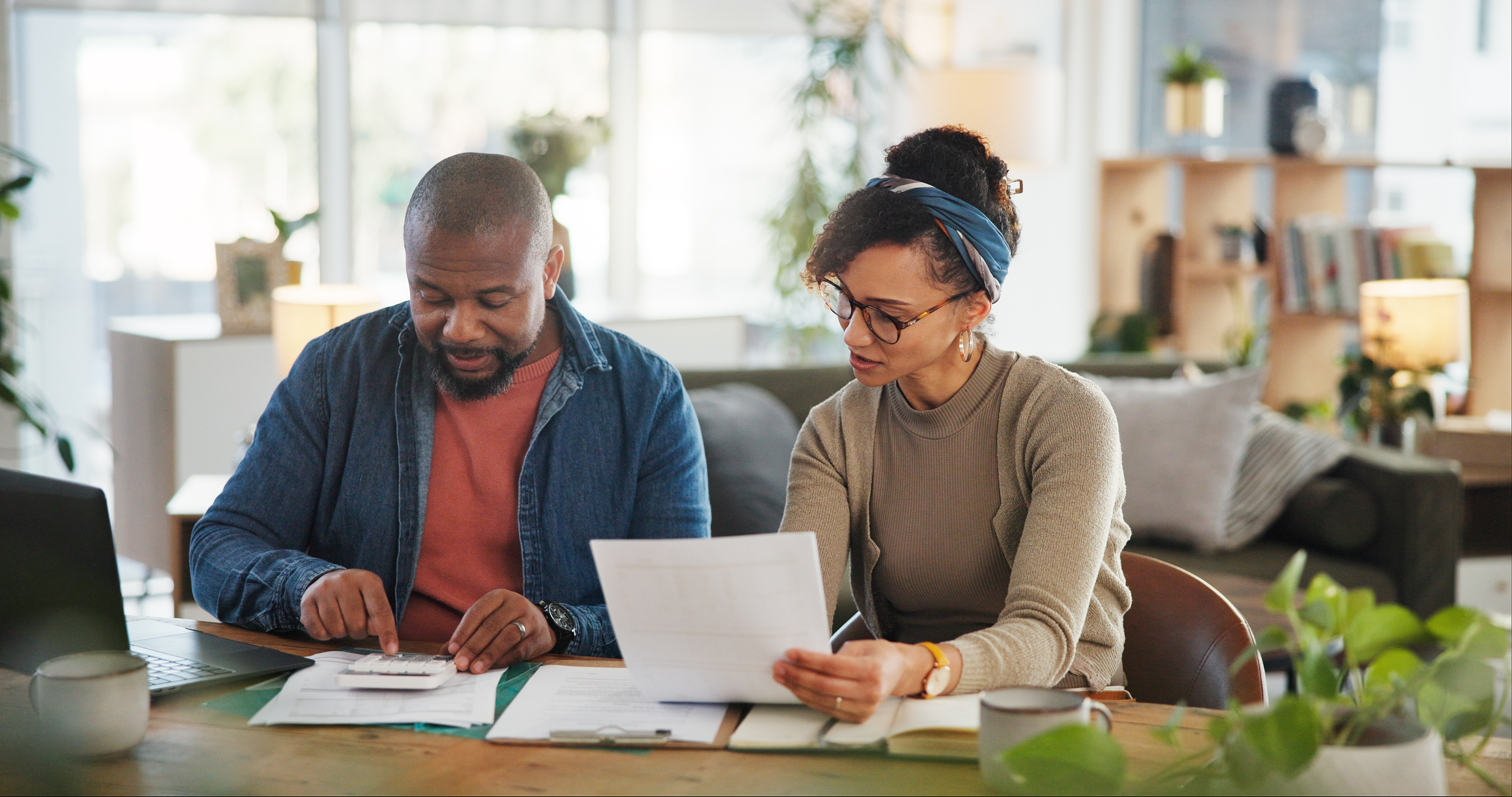 Couple at home working on finances together.